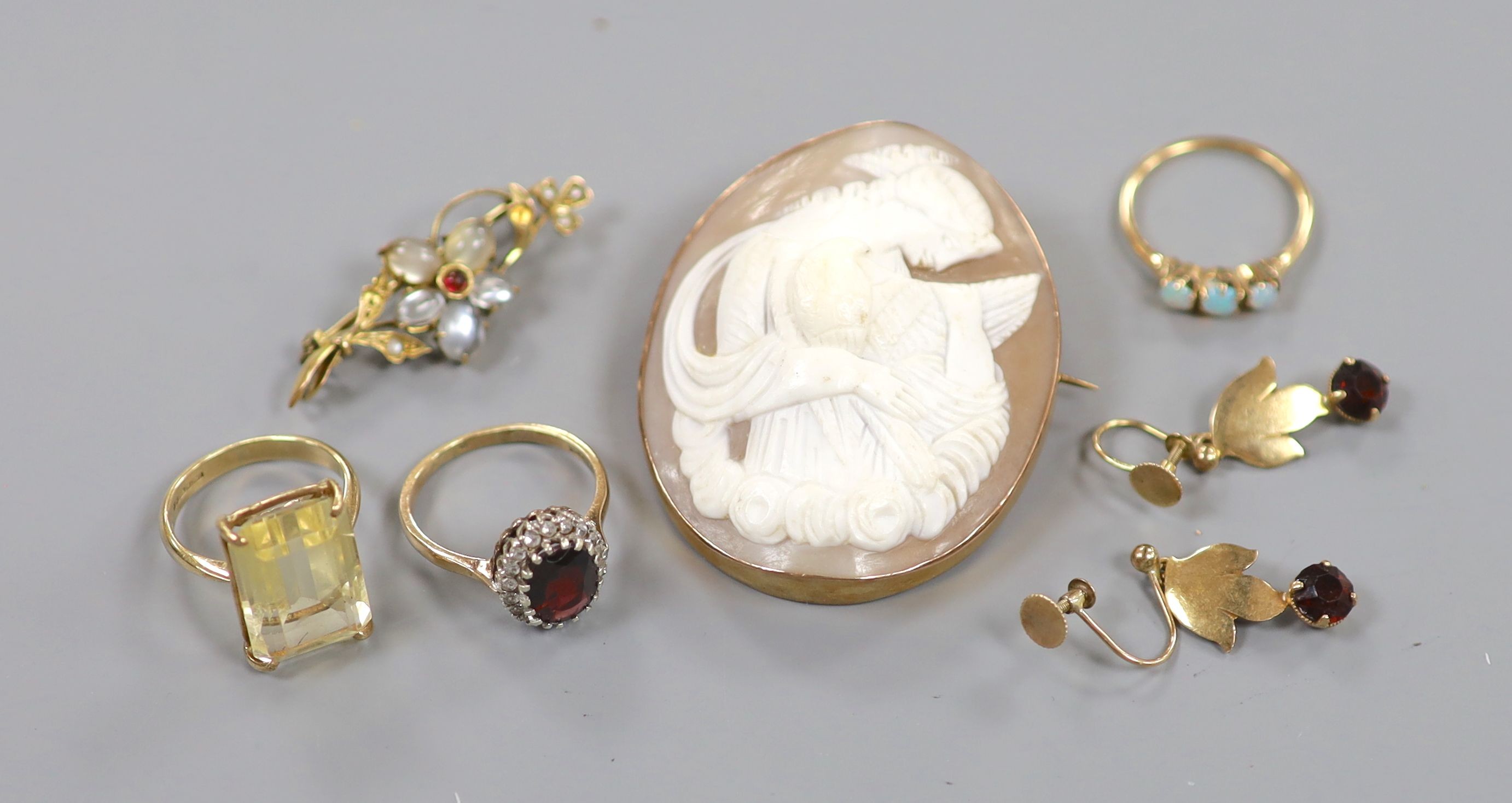 A 9ct gold and citrine set ring, two other gem set rings, a 9ct mounted cameo brooch, a yellow metal and gem set bar brooch and a pair of 9ct gold and gem set drop earrings.